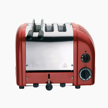 A red Dualit Combi 2+1 Classic Toaster with a stainless-steel body and mechanical timer control on the front.