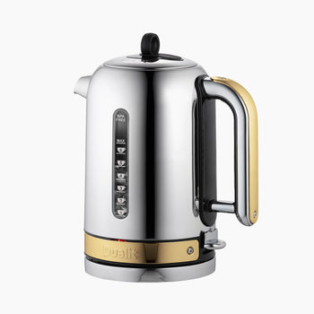 A silver stainless-steel electric kettle with a sleek design and brass accents, featuring a handle and temperature control buttons on the spout.